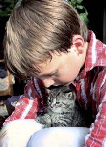 Sam holding his cat after allergy treatment