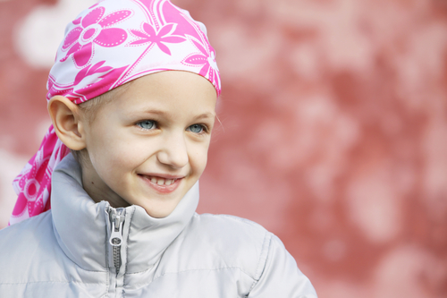 Beautiful caucasian girl wearing a head scarf due to hair loss from chemotherapy fighting cancer