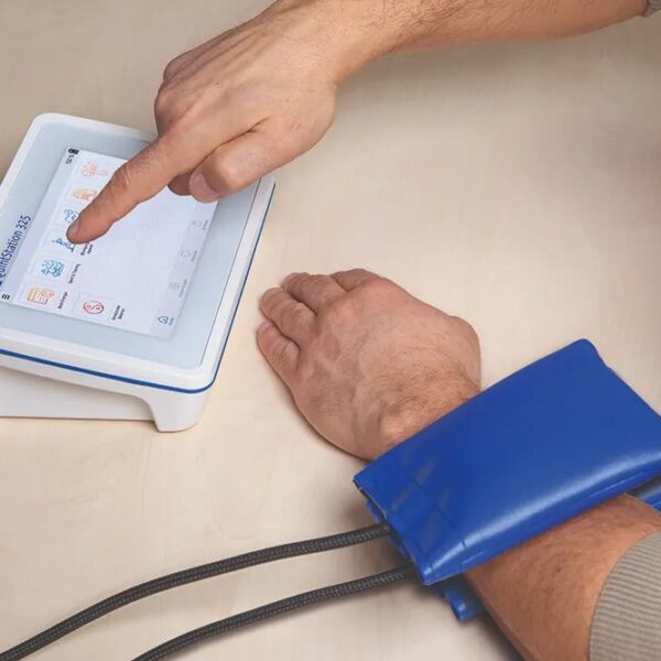 QuintStation 325 in use, selecting a programme with a pad applicator on the forearm