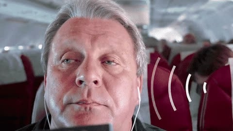 A man wearing noise-cancelling headphones, an everyday example of signal inversion